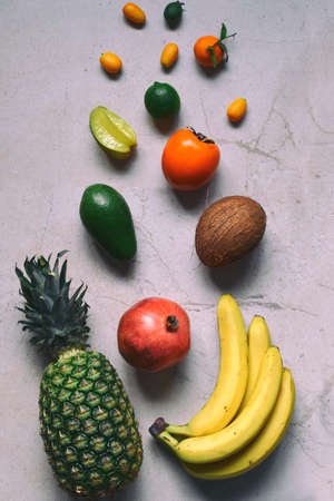 Mix of ripe tropical fruits with avocado, mango, coconut, carambola, banana, kumquat, pitahaya, kiwi Superfood background Vegetarian food Copy spaceの写真素材