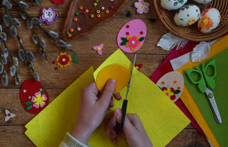Making of handmade easter eggs from felt with your own hands. Children's DIY concept. Making Easter decoration or greeting card.の写真素材