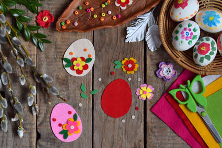 Making of handmade easter eggs from felt with your own hands. Children's DIY concept. Making Easter decoration or greeting card. Step 1. Cut out the eggの写真素材
