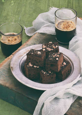 Pieces of cake chocolate brownies on wooden background. Homemade baking. Copy space.