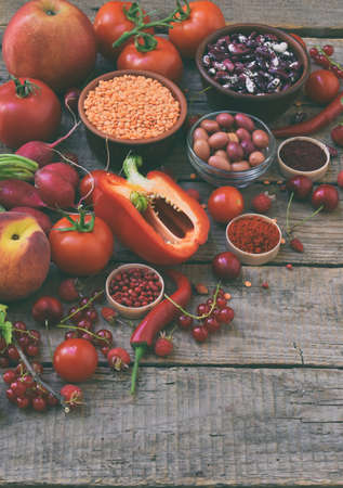 Collection of fresh red fruits, vegetables and bean. Healthy food concept. Vegetarian product. Organic Raw Produceの写真素材