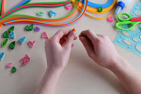 Quilling technique. Handmade crafts on holiday: Birthday, Mother's or Father's Day, March 8, Wedding. Children's DIY concept. Twisting of paper strips, elements for making greeting card. Step 2の写真素材