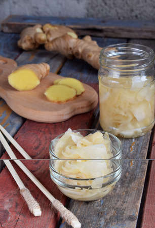 Pickled ginger slices and wooden chopsticks. Ingredient for sushi. Healthy food. Traditional Japanese condimentの写真素材