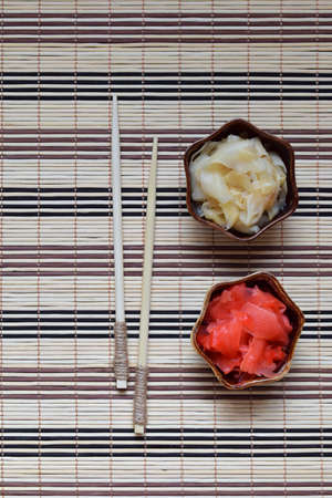 Pickled ginger slices and wooden chopsticks. Ingredient for sushi. Healthy food. Traditional Japanese condimentの写真素材