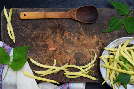 Fresh bio organic asparagus beans on a wooden background. Healthy food. Copy space border. Mockup for menu or recipeの写真素材