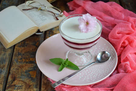 Panna cotta. Layered vanilla milk berry dessert. Pannacotta in glass with strawberry jello. Traditional italian dessert. Copy spaceの写真素材