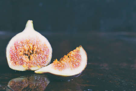 A very ripe blue fig on a dark background. Organic fruits. Healthy food.の写真素材
