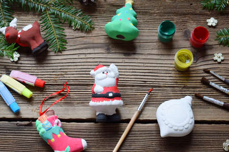 Painting Christmas toys from porcelain for decorations. Making clay toy with your own hands. Children's DIY concept. Handmade crafts on holiday. Master class of art.の写真素材