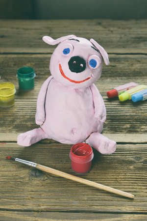 Making clay toy. Painting pig with gouache. Creative leisure for children. Supporting creativity, learning by doing, DIY project, hand craft. Master class of art.の写真素材