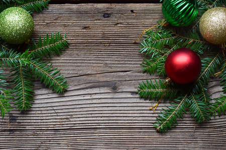 The branches of spruce on a wooden background. Happy New Year and Merry Christmas concept. Greeting card or festive background. Copy space.の写真素材
