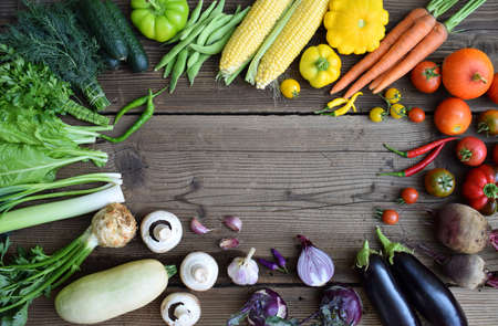 White, yellow, green, orange, red, purple fruits and vegetables on wooden background. Healthy food....