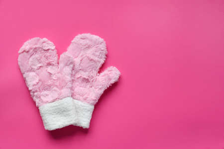 Fur mittens on a pink background. Warm gift or winter comfortable clothes concept. Copy space. Top view.の写真素材