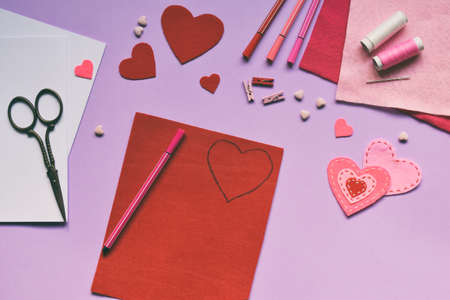 Making of handmade Valentine greeting card from felt. Children's DIY, hobby concept, gift with your...