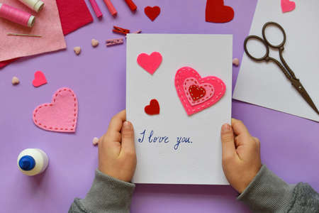 Making of handmade Valentine greeting card from felt. Children's DIY, hobby concept, gift with your own hands. Valentine's Day decorationの写真素材