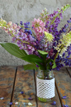 Pink, purple lupine flowers bouquet in vase. Birthday, Mother's day, Valentine's Day, March 8, Wedding card or invitation. Festive Floral decorative background. Copy space.の写真素材