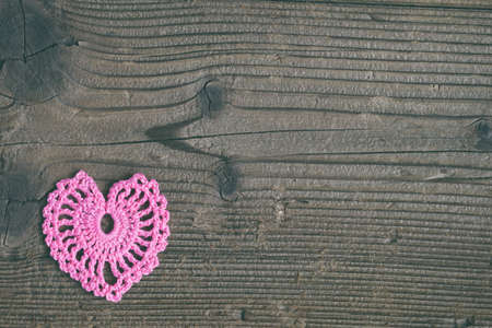 Crochet openwork hearts on wooden background. Valentines Day greeting card concept. Valentine Day craftsの写真素材