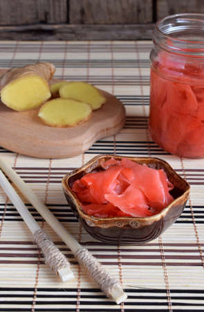 Pickled ginger slices and wooden chopsticks. Ingredient for sushi. Healthy food. Traditional Japanese condimentの写真素材