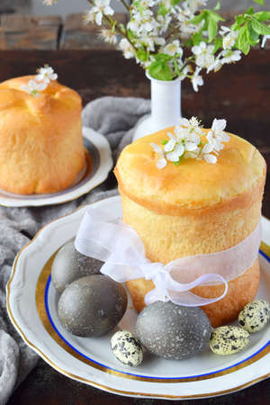 Happy Easter concept. Sweet bread with dried fruits and colored eggs. Holidays breakfast. Orthodox...