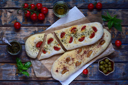 Traditional Italian Focaccia with tomatoes, basil, garlic and sumach. Homemade pastry. Flat bread....