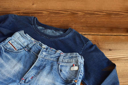 The Teenager casual outfit. Boys shoes, clothing and accessories on wooden background - sweater,...
