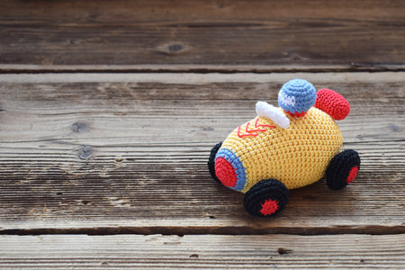 Colored crochet racing car. Toy for babies and toddlers to learn mechanical skills and colors. handmade crafts. DIY concept.の写真素材