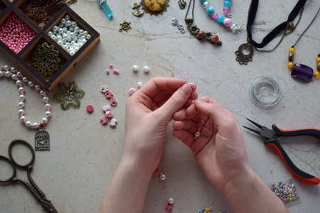 Making the jewelry. Needlework accessories for creating bracelet, chain from beads. DIY project....