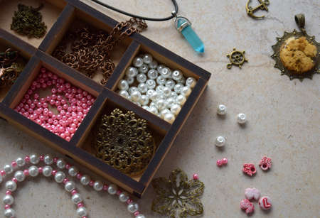 Making the jewelry. Needlework accessories for creating bracelet, chain from beads. DIY project. small business. Income from hobby.の写真素材