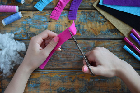 Making pink lama. Sewing toys from felt with your own hands. DIY concept for children. Handmade...