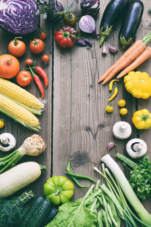 White, yellow, green, orange, red, purple fruits and vegetables on wooden background. Healthy food. Multicolored raw food. Copy spaceの写真素材