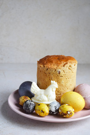 Traditional Easter Kulich with Colorful Painted Eggs and Quail Eggs on Ceramic Plate. Homemade...