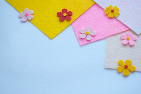 Handmade felt floral arrangement, DIY craft materials, colorful fabric petals, spring-themed sewing project, creative textile art, soft pastel background, home decoration ideaの写真素材