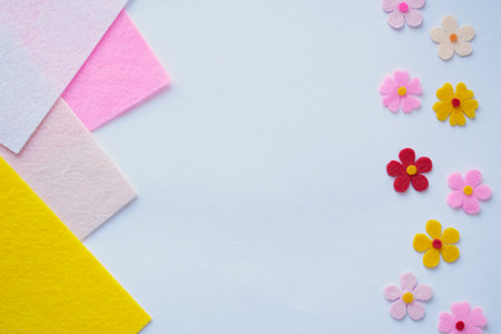Handmade felt flowers on pastel background, DIY craft materials, creative sewing, colorful fabric petals, floral design, soft texture, home decoration idea, artistic compositionの写真素材