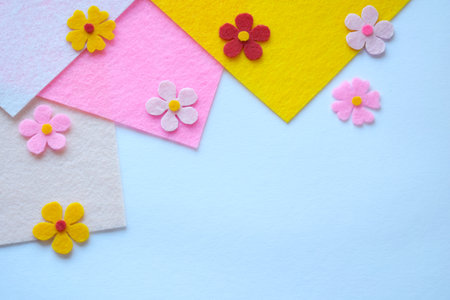 DIY felt flower arrangement, pastel background, handmade textile craft, colorful floral design, creative home decor, soft fabric petals, artistic sewing, spring-inspired compositionの写真素材