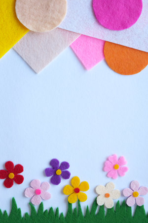 Handmade felt spring meadow, colorful textile flowers, DIY floral craft, green grass, soft petals, home decoration, creative sewing project, pastel background, nature-inspired designの写真素材