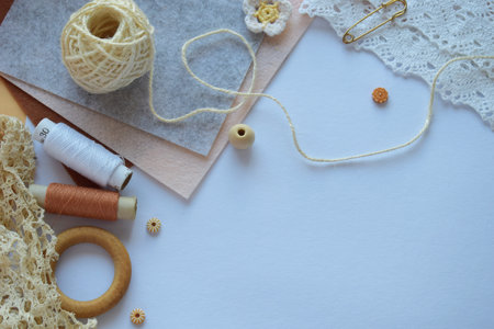Flat lay of vintage handmade lace yarn and natural threads on a white surface perfect for DIY artistic projects sewing workshops and creative hobby flat laysの写真素材