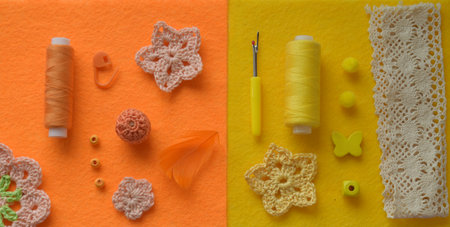 Top-down layout of yellow, orange, and neutral crochet accessories, threads, needles, and decorative supplies aligned on soft felt background for creative organization and DIY craft design projects.の写真素材