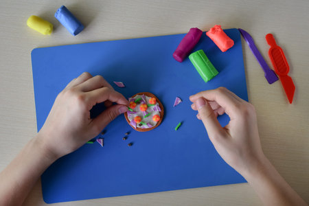 Kids decorating plasticine donut flat lay creative learning activity handmade food craft fine motor...