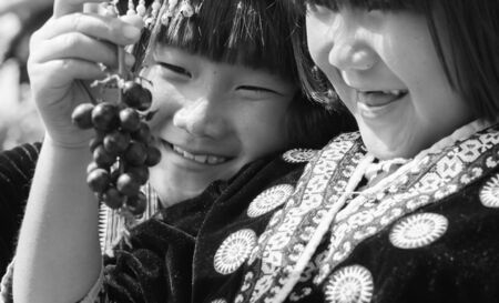 Hill tribe child so happy to have a grapeのeditorial素材