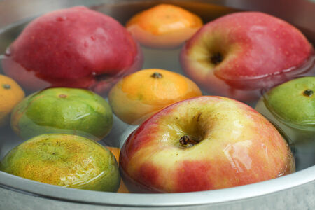 Cleaning fruit in the bowl with waterの写真素材