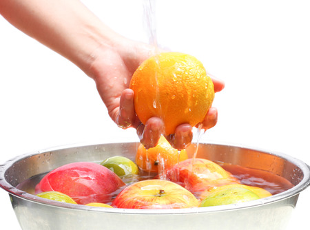 Fruit is being washed in the waterの写真素材