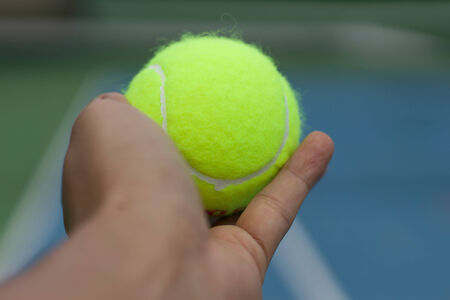 hand hole tennis ball ready to servの写真素材