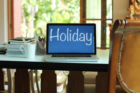 Cup of Coffee and Laptop and Holiday planの写真素材