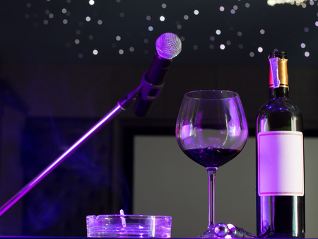 Microphone and a glass of wine in music roomの写真素材