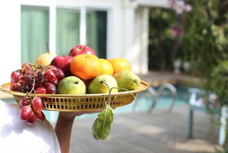 People carry fresh fruits on golden in blur backgroundの写真素材
