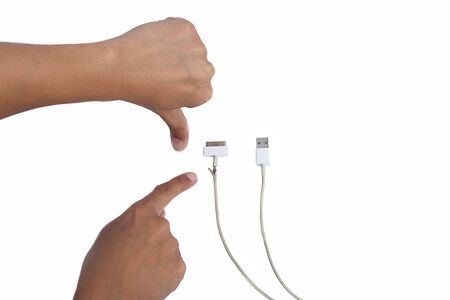 Hand pointing a damaeg USB Cable on white backgroundの写真素材