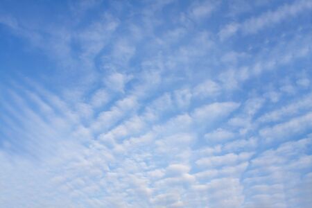 Beautiful blue sky background with tiny white cloudsの写真素材