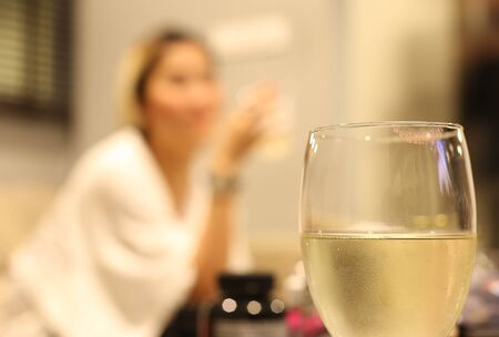 White wine glass with lipstick print on glassの写真素材