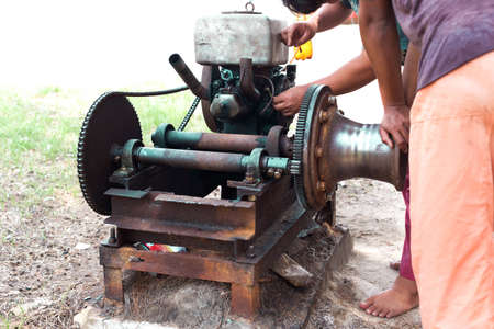 Select focus of Working men repair an old engine in blur backgroundの写真素材