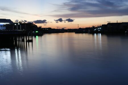 River to the Sea in Fisherman village in Thailand with stunning silhouette Sunset viewの写真素材