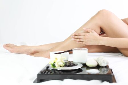 female legs with spa composition isolated in with backgroundの写真素材
